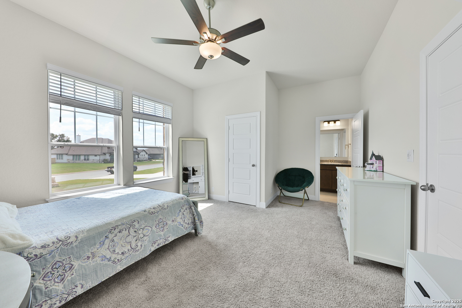 195 Piper Street Castroville, TX 78009 - Photo 29 of 47 a bedroom with a bed and a chandelier