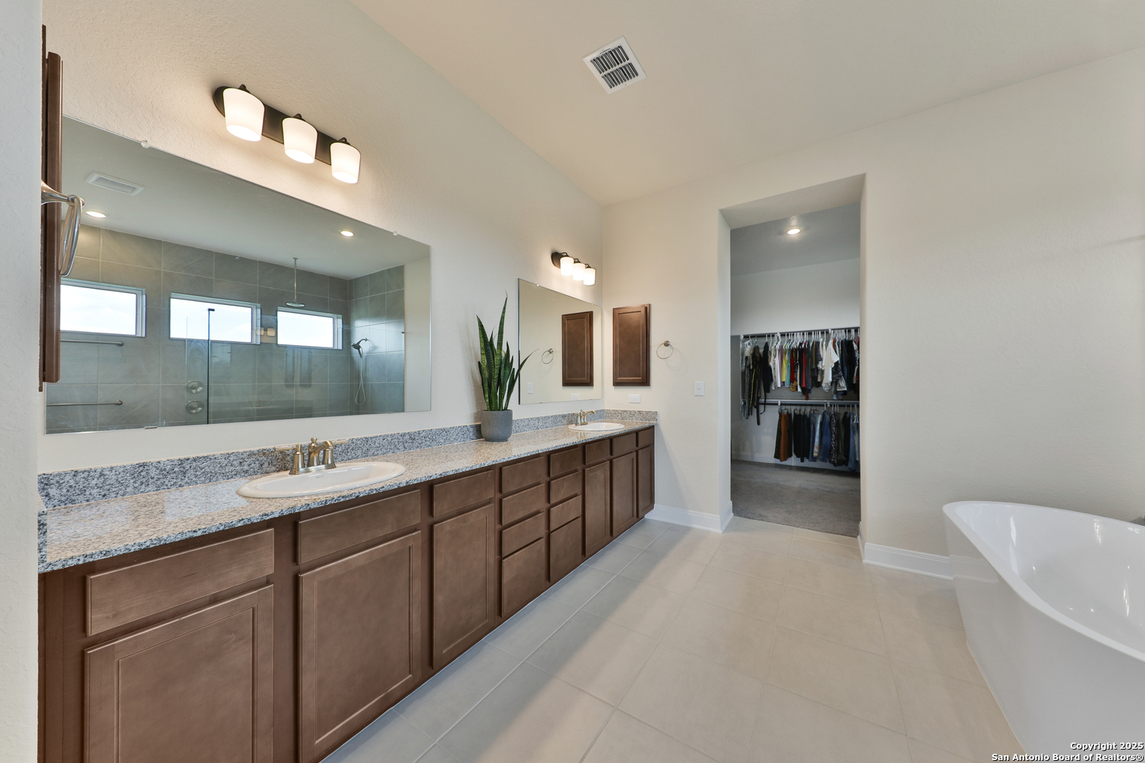195 Piper Street Castroville, TX 78009 - Photo 35 of 47 a large bathroom with a large mirror vanity and sink