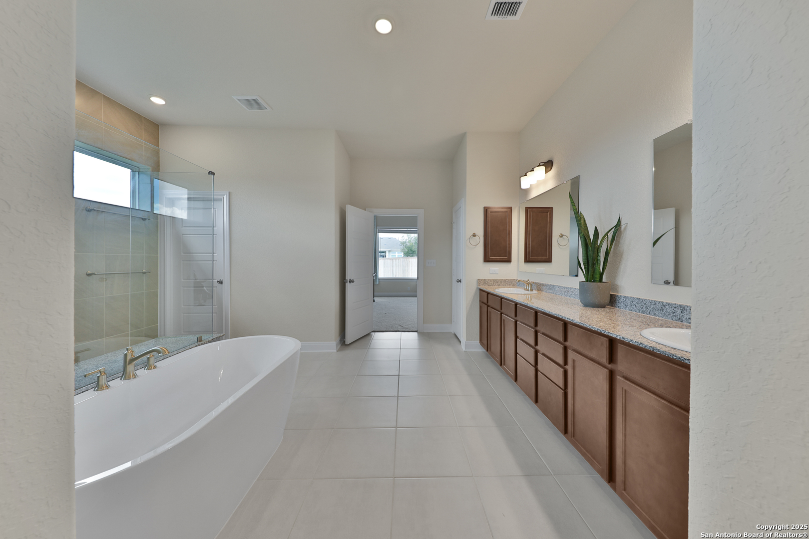 195 Piper Street Castroville, TX 78009 - Photo 37 of 47 a bathroom with a double vanity sink and a large mirror