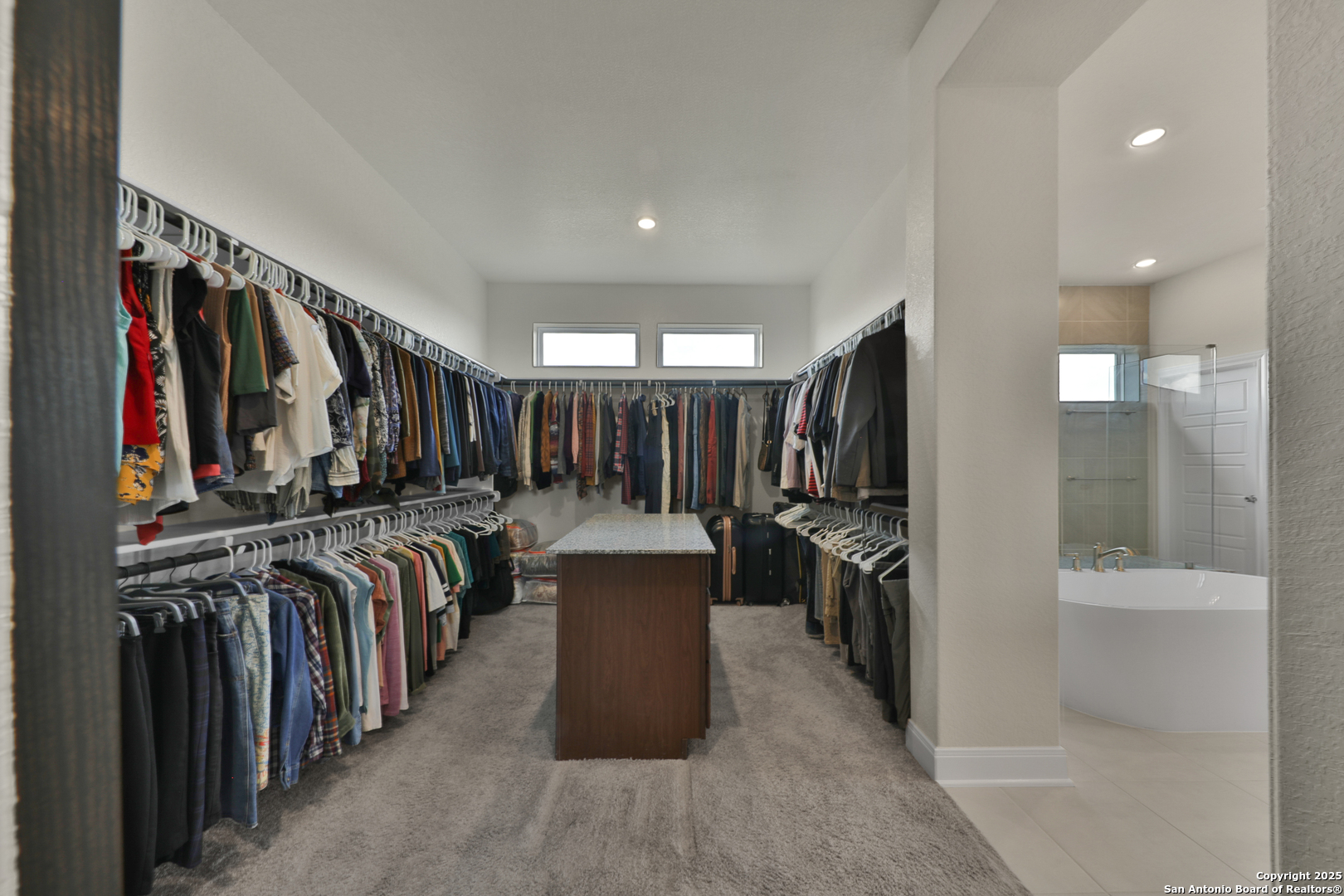 195 Piper Street Castroville, TX 78009 - Photo 38 of 47 a view of walk in closet with clothes and shoes