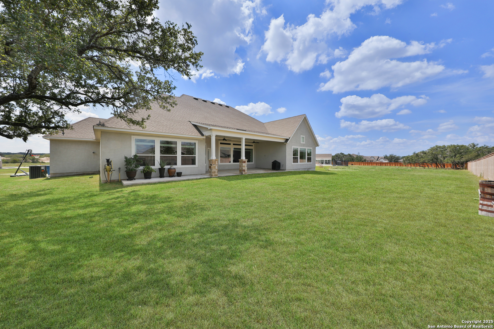 195 Piper Street Castroville, TX 78009 - Photo 44 of 47 a front view of a house with a garden and trees