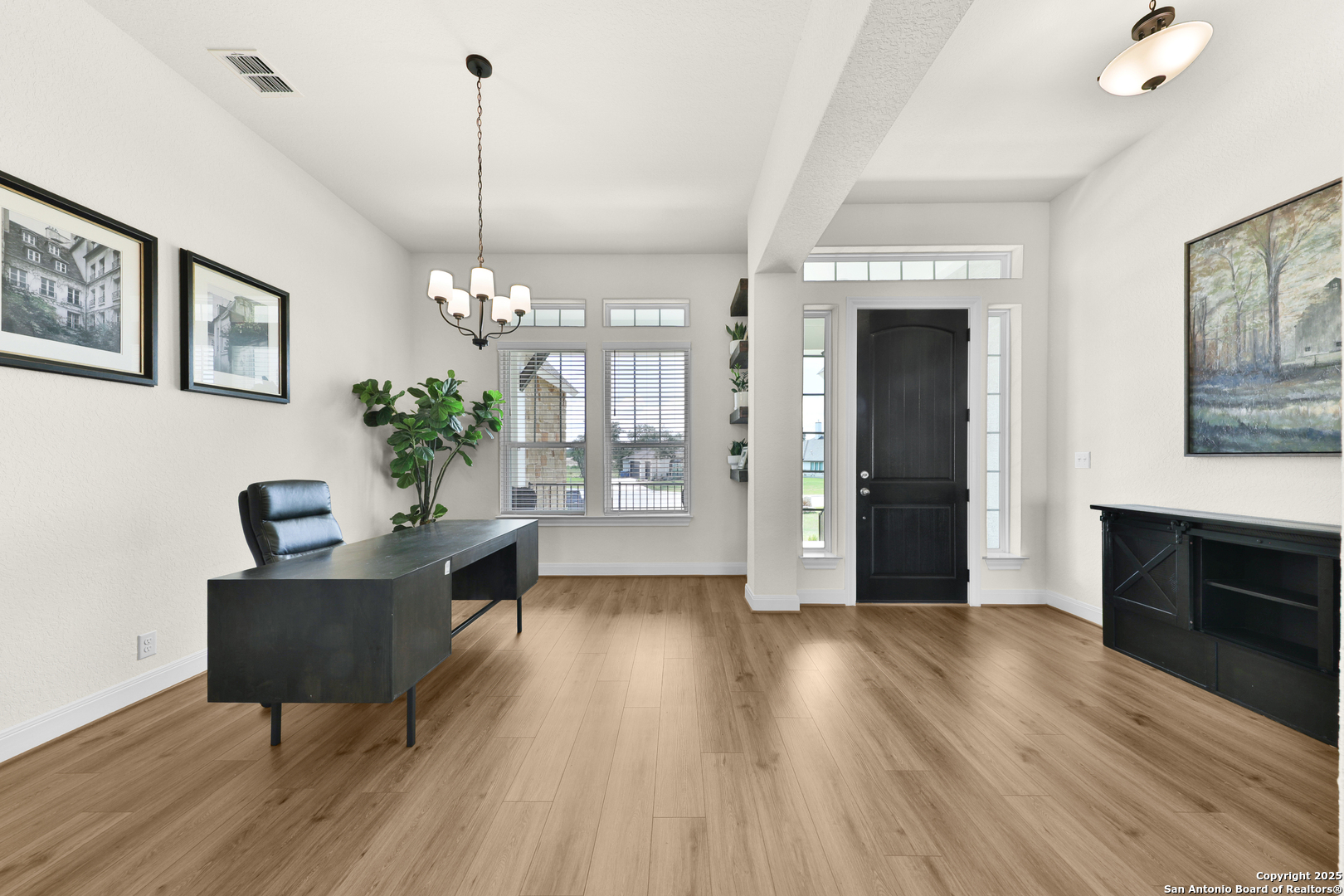 195 Piper Street Castroville, TX 78009 - Photo 5 of 47 a living room with furniture and a chandelier