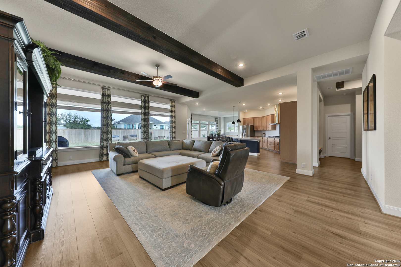 195 Piper Street Castroville, TX 78009 - Photo 8 of 47 a living room with furniture large windows and wooden floor