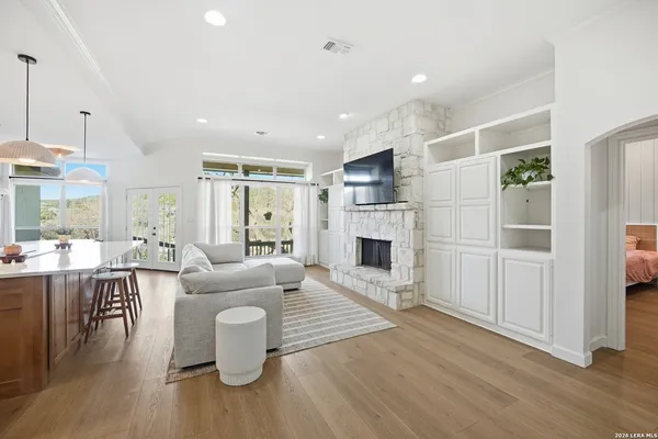 a living room with furniture a fireplace and wooden floor