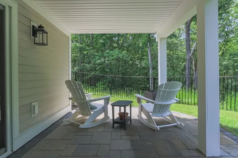 a view of a porch with chairs in patio