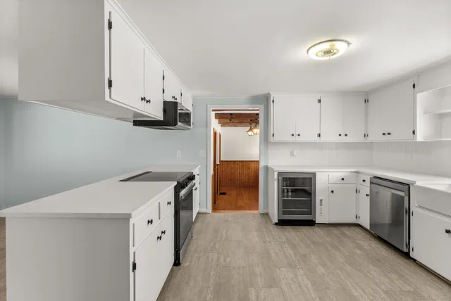 a kitchen with a stove top oven sink and cabinets