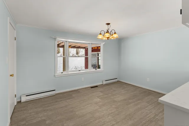 an empty room with windows and painted walls