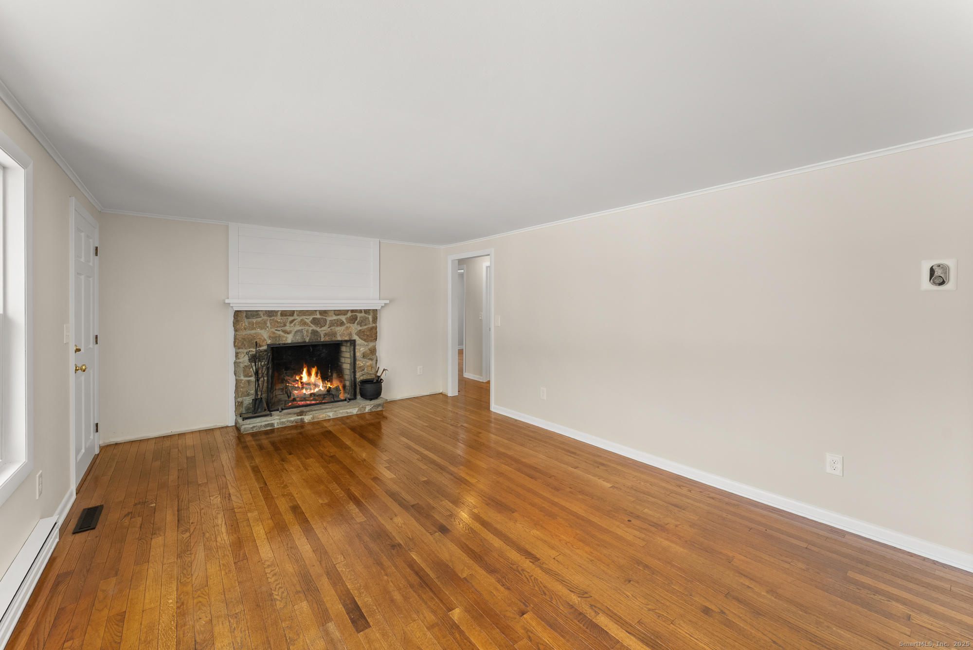 52 B Fuller Mountain Road Kent, CT 06757 - Photo 18 of 25 a view of empty room with wooden floor and fireplace