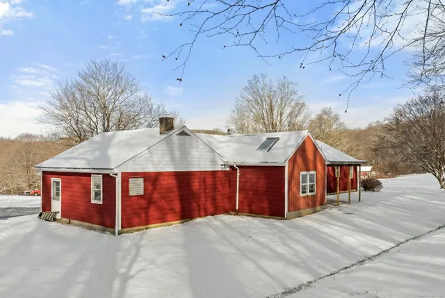 a view of a house with large trees and a barn