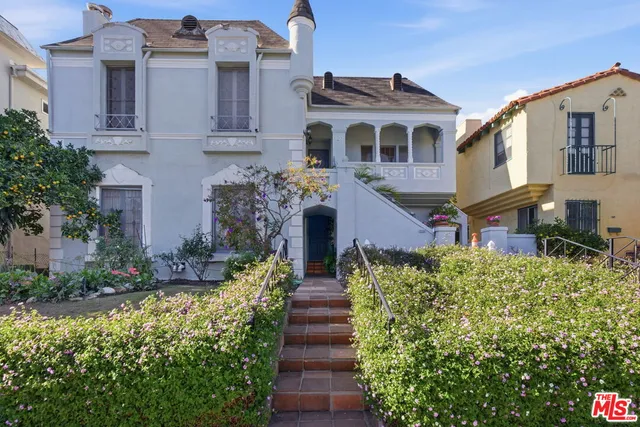a view of a building with many windows and plants