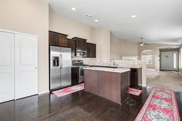 a kitchen with stainless steel appliances granite countertop a sink stove and refrigerator