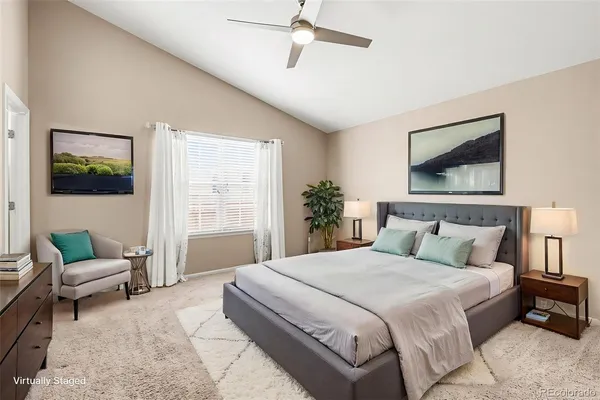 an empty room with closet and fan