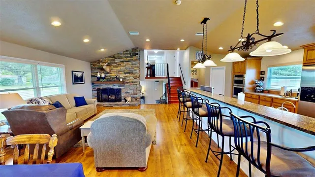 a living room with fireplace furniture dining table and a fireplace