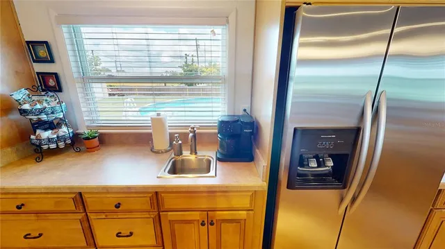 a living room with furniture a flat screen tv and a large window