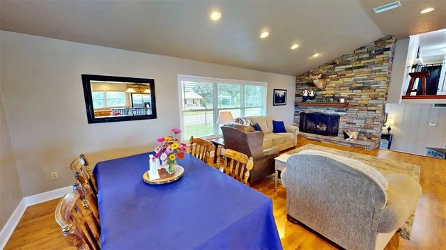 a view of a dining room with furniture a chandelier and wooden floor