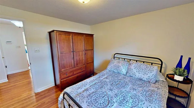 a bed sitting in a bedroom next to a window