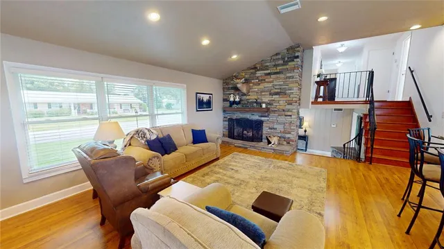a living room with furniture and stairs