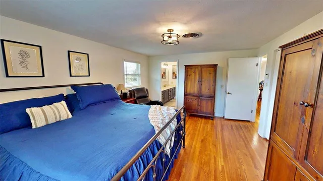 a hallway with painting on the wall and a shower