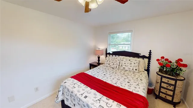 a view of a livingroom with furniture a window and wooden floor
