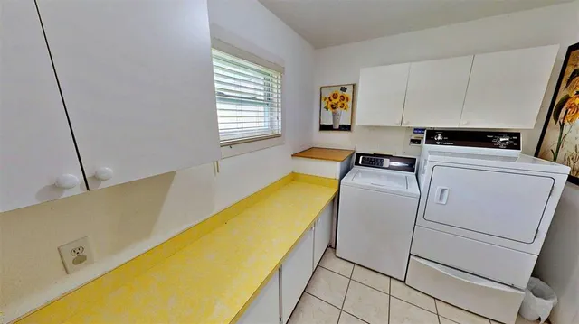 a view of a hallway with stairs and furniture