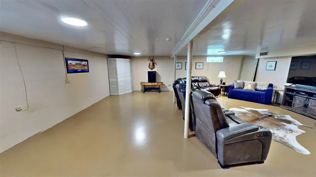 a living room with furniture fireplace and a window