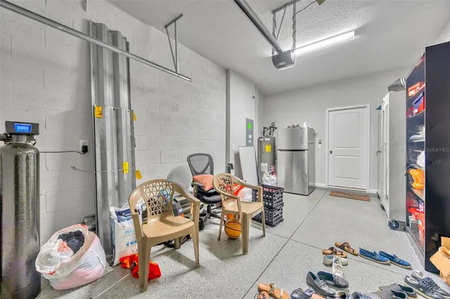 a spacious bedroom with a bed and a chandelier