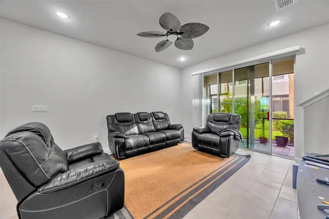 a bed room with a bed and a ceiling fan