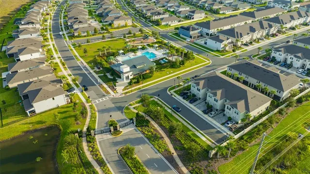 a view of an empty room with closet and mirror