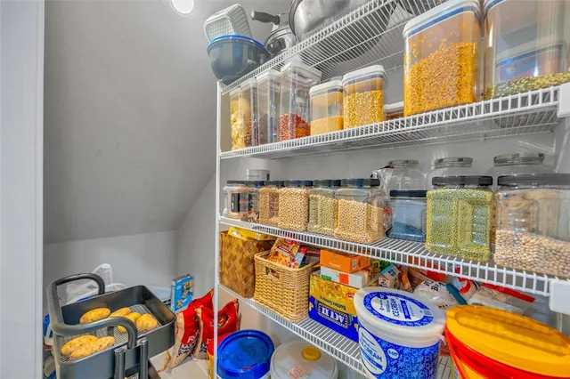 a view of a porch with a floor to ceiling window and potted plants