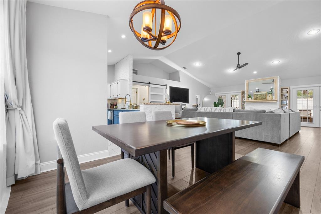 5628 Southwest 104 Terrace Gainesville, FL 32608 - Photo 13 of 31 a kitchen with a dining table chairs stove and cabinets