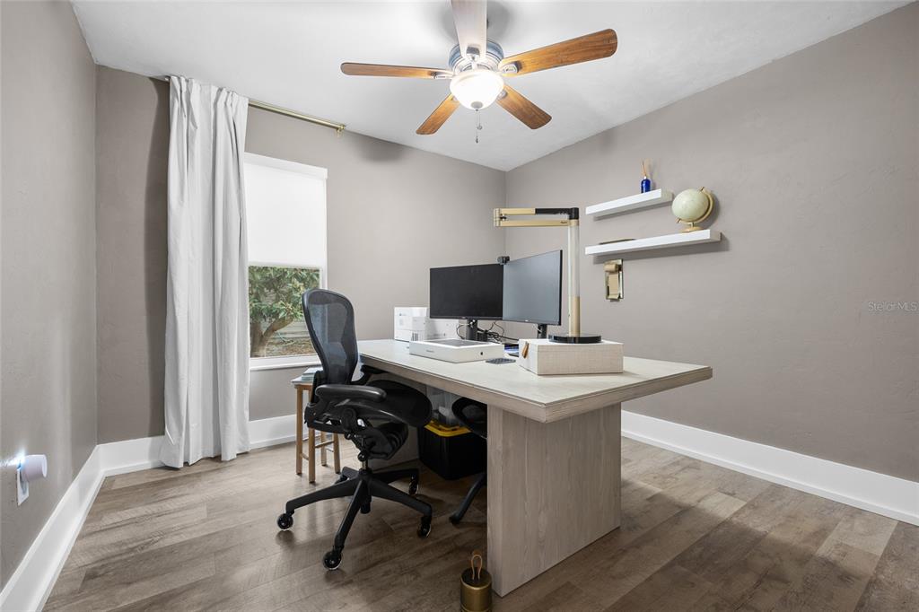 5628 Southwest 104 Terrace Gainesville, FL 32608 - Photo 15 of 31 a view of a workspace with furniture and a window