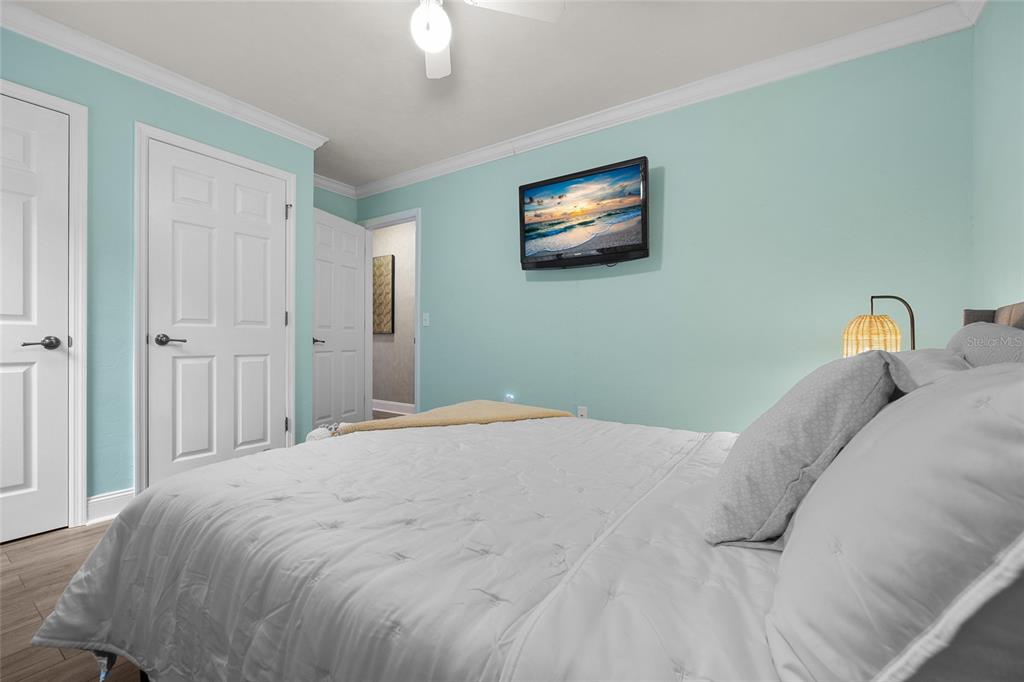 5628 Southwest 104 Terrace Gainesville, FL 32608 - Photo 17 of 31 a bedroom with a bed and a chandelier