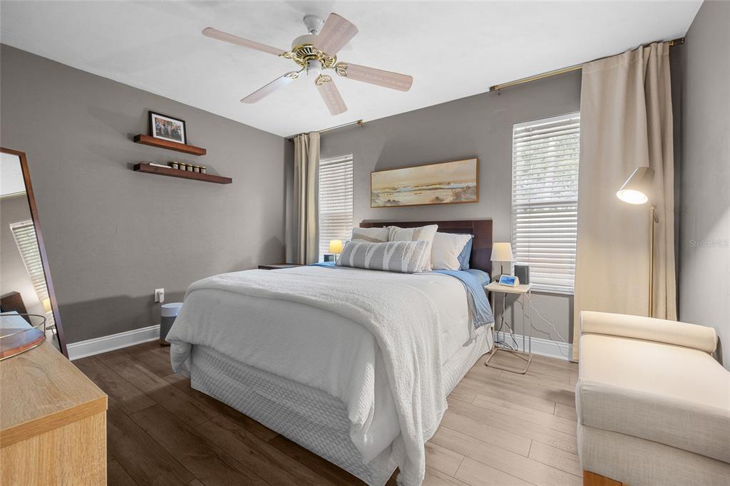 5628 Southwest 104 Terrace Gainesville, FL 32608 - Photo 18 of 31 a bedroom with a large bed and a chandelier