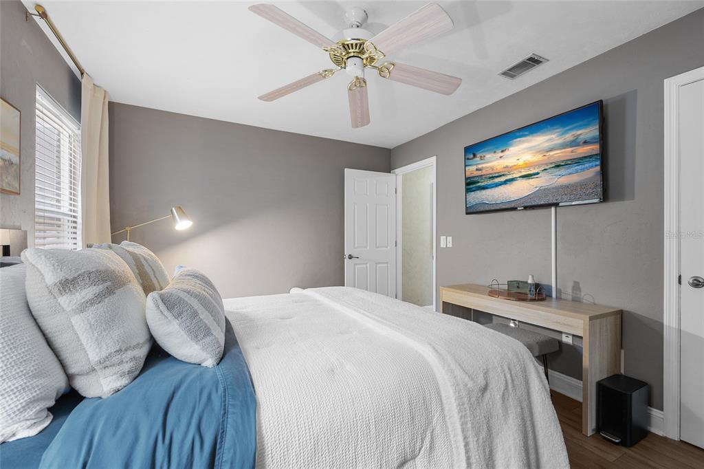 5628 Southwest 104 Terrace Gainesville, FL 32608 - Photo 19 of 31 a bedroom with a bed and a flat screen tv