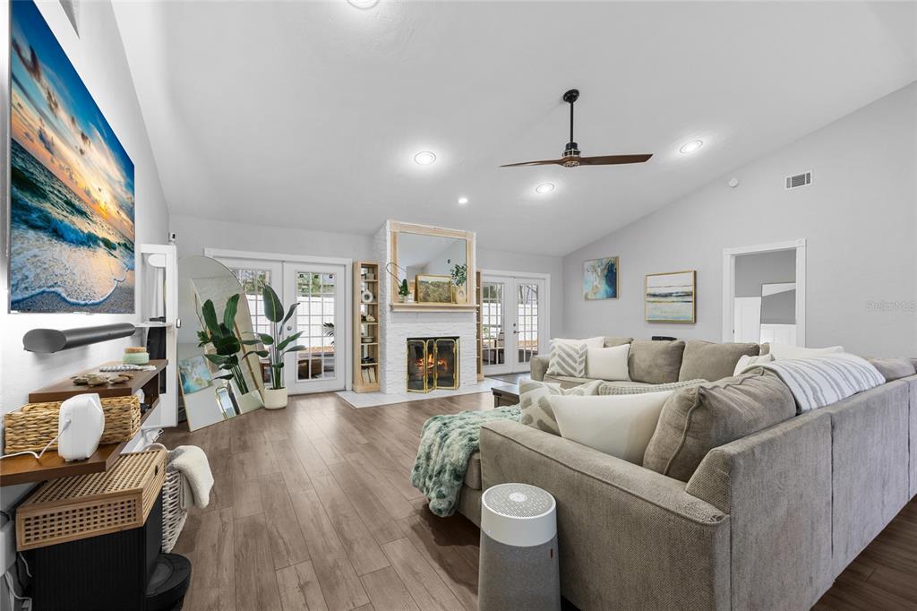 5628 Southwest 104 Terrace Gainesville, FL 32608 - Photo 2 of 31 a living room with furniture a fireplace and a chandelier