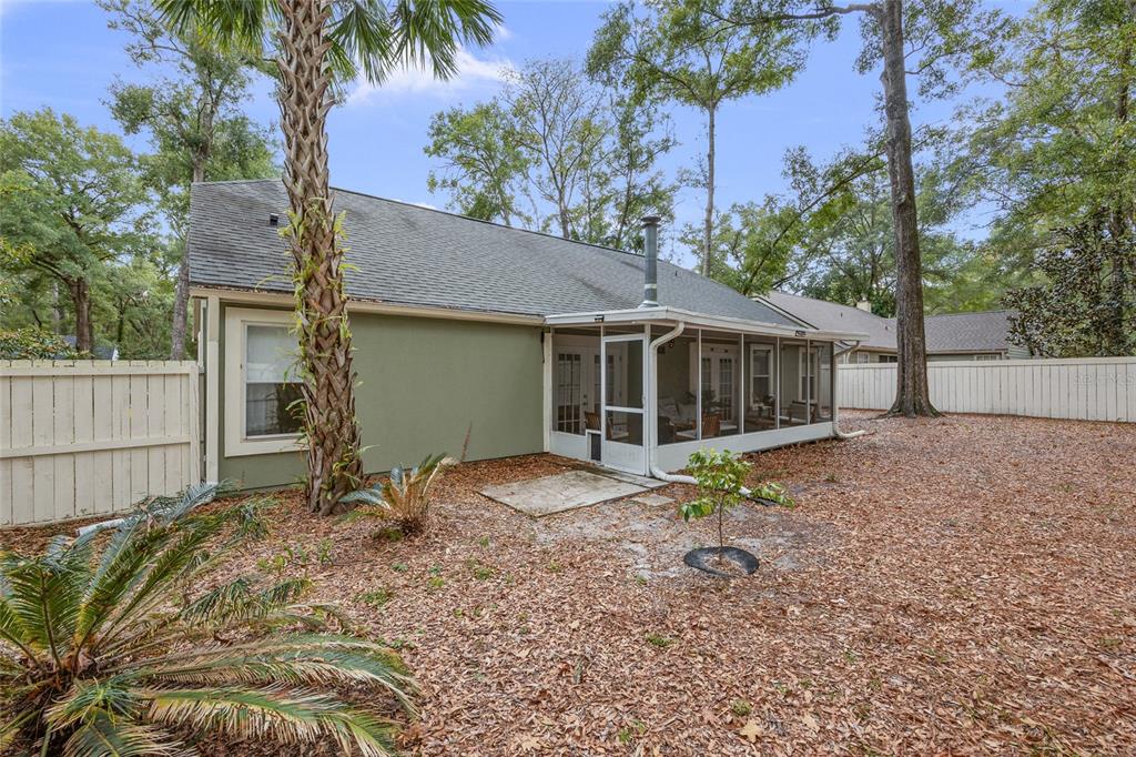 5628 Southwest 104 Terrace Gainesville, FL 32608 - Photo 24 of 31 a backyard of a house with table and chairs