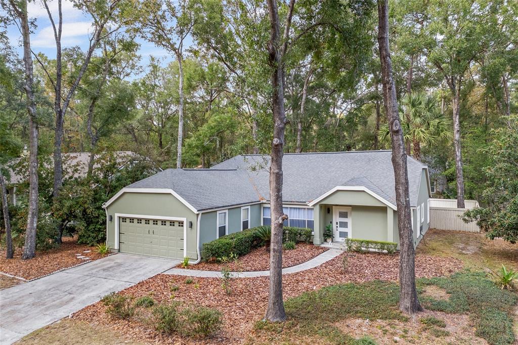 5628 Southwest 104 Terrace Gainesville, FL 32608 - Photo 25 of 31 a front view of a house with garden