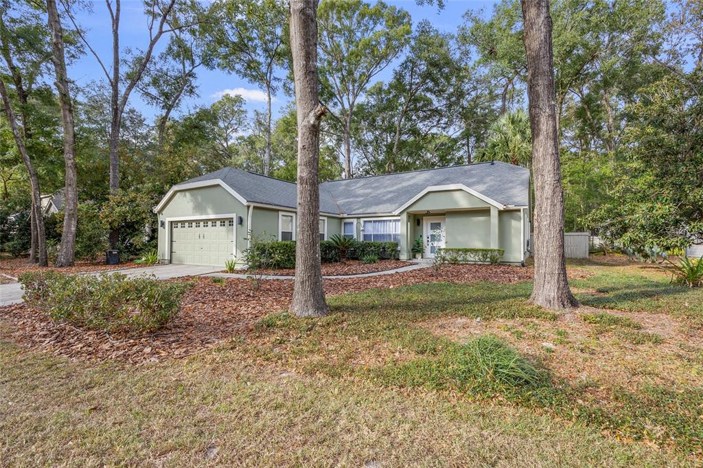 5628 Southwest 104 Terrace Gainesville, FL 32608 - Photo 29 of 31 a front view of a house with garden