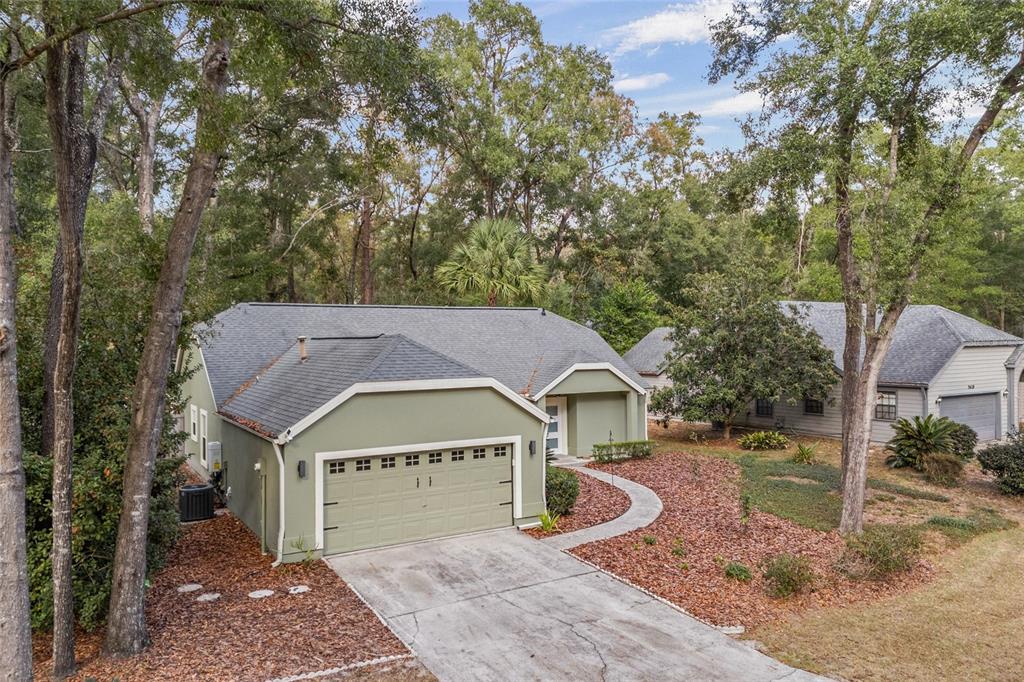 5628 Southwest 104 Terrace Gainesville, FL 32608 - Photo 30 of 31 a front view of a house with garden