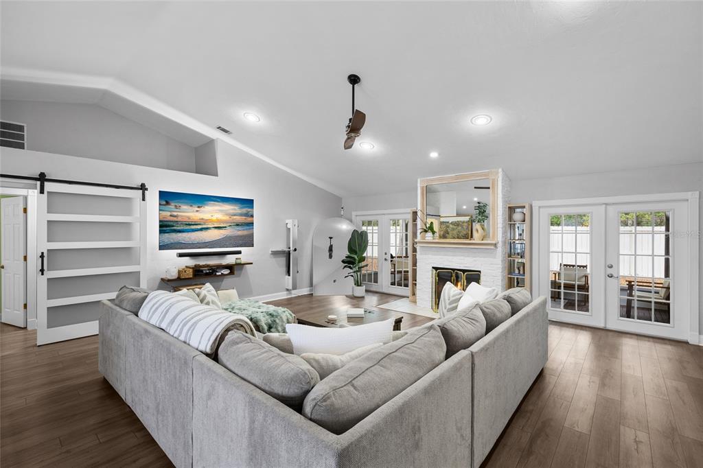 5628 Southwest 104 Terrace Gainesville, FL 32608 - Photo 3 of 31 a living room with furniture a ceiling fan and a flat screen tv