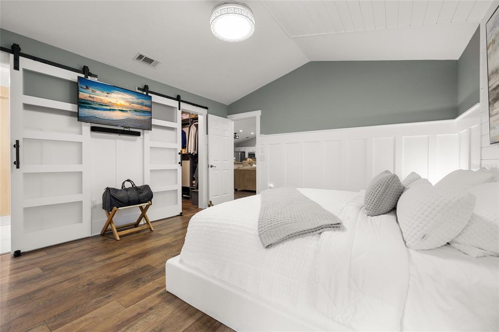 5628 Southwest 104 Terrace Gainesville, FL 32608 - Photo 7 of 31 a bedroom with a bed and a chair