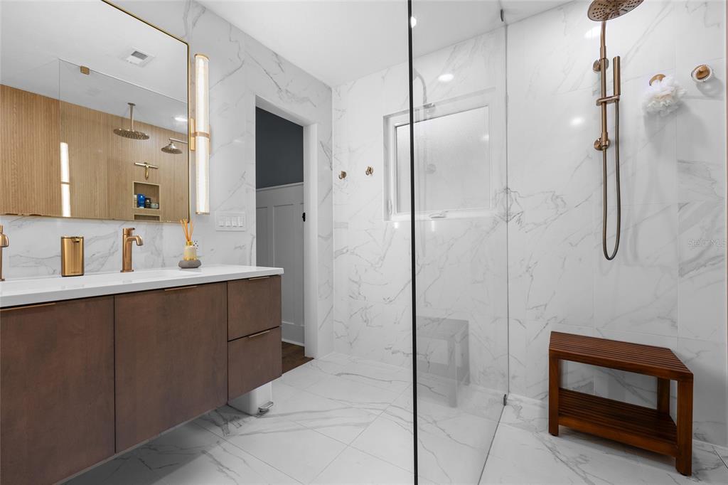 5628 Southwest 104 Terrace Gainesville, FL 32608 - Photo 9 of 31 a bathroom with a double vanity sink a toilet and shower