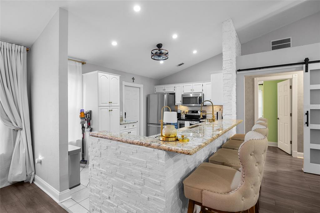 5628 Southwest 104 Terrace Gainesville, FL 32608 - Photo 10 of 31 a living room with furniture and a wooden floor