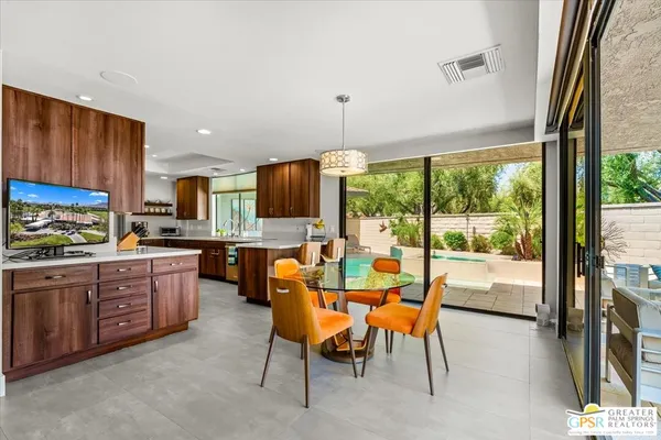 a kitchen with a table chairs and a view of living room
