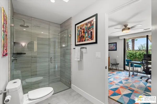 a bathroom with a granite countertop sink a mirror and shower