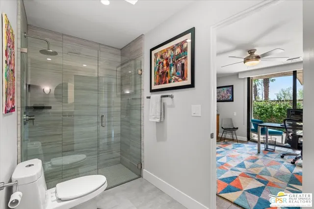 a bathroom with a granite countertop sink a mirror and shower