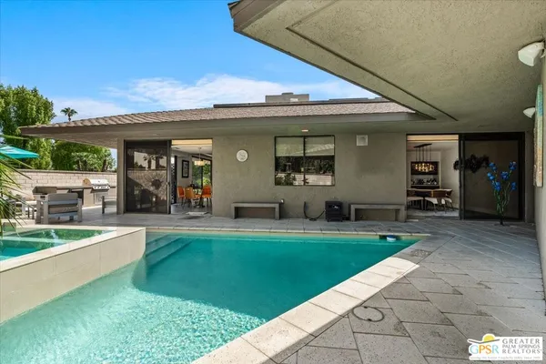 a view of a swimming pool with outdoor seating