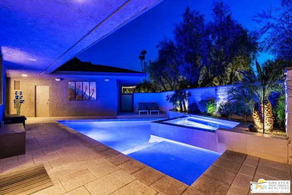 a view of a swimming pool with seating space