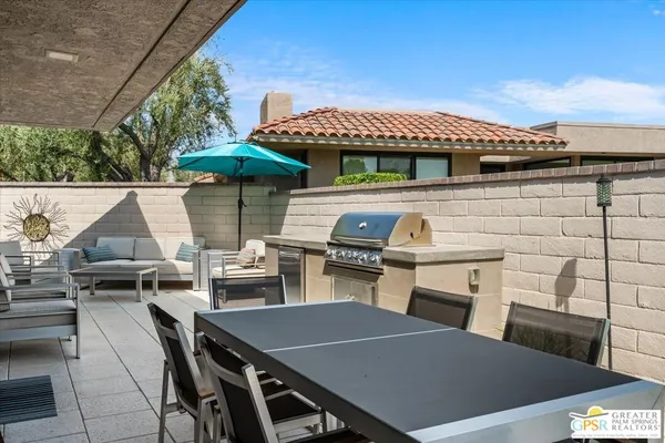 a view of a patio with table and chairs and potted plants