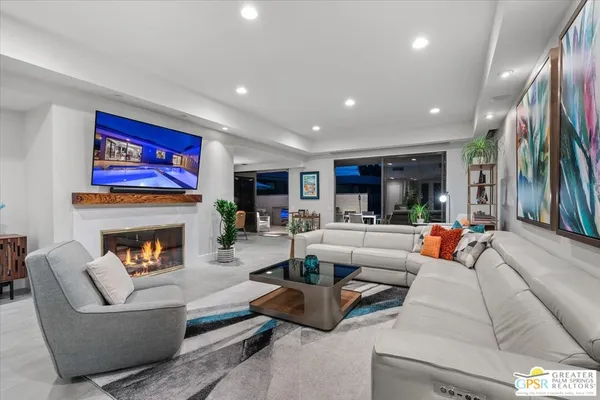 a living room with furniture and a potted plant